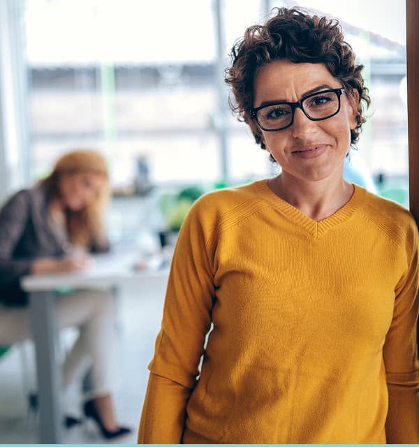 Woman standing leaning on a wall